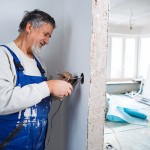 Senior man working on the electrical installations in a freshly